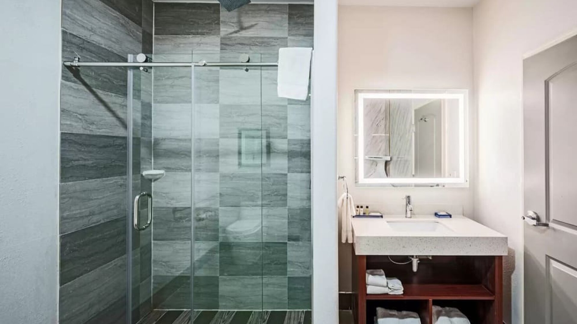 Guest bathroom with shower at The Leo Collection, An Ascend Collection Hotel.