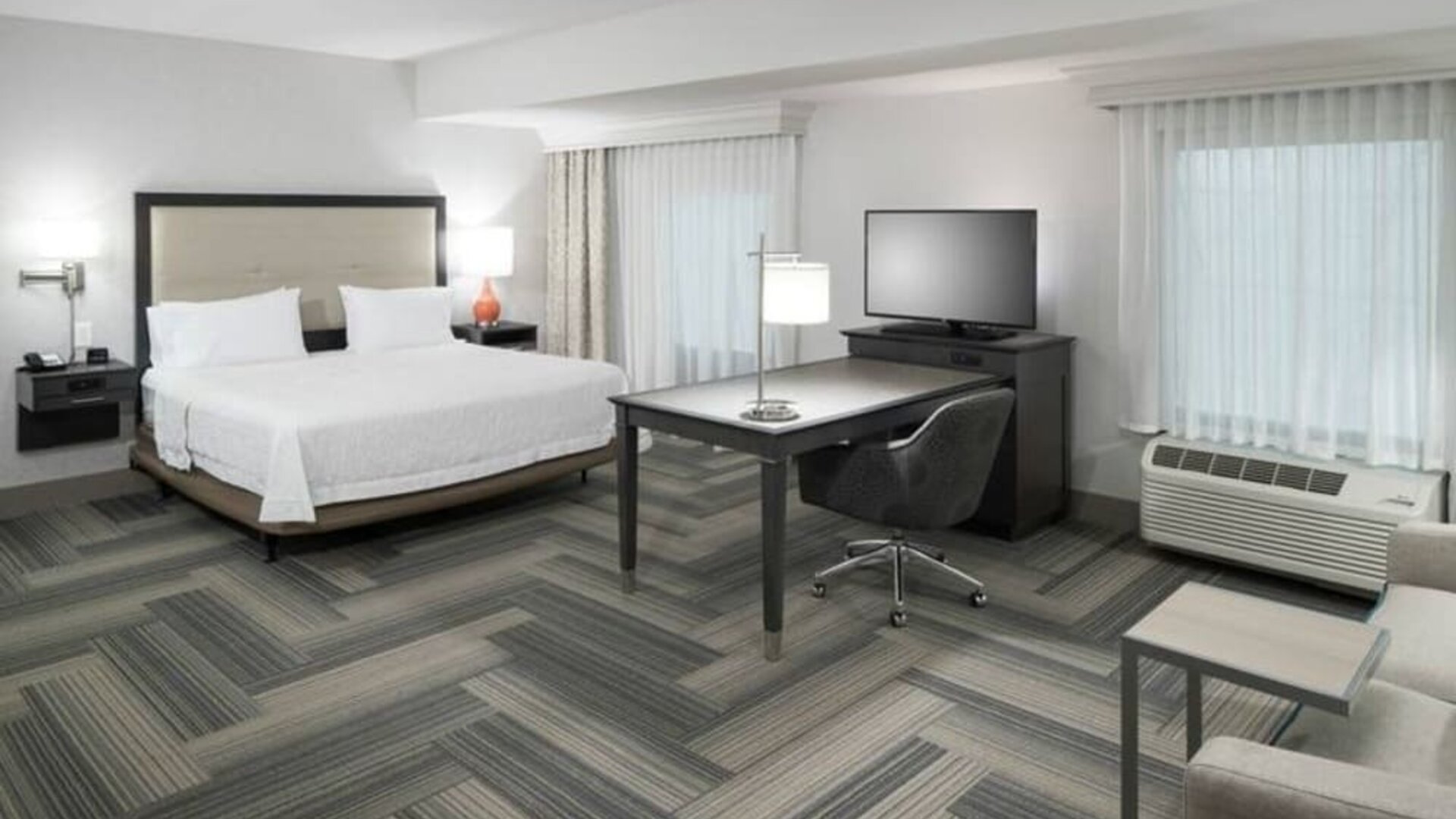 King bed with work desk and living area at Hampton Inn & Suites By Hilton Atlanta Perimeter Dunwoody.