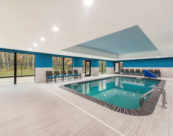 Relaxing indoor heated pool with lounge chairs at Hampton Inn & Suites Benton Harbor.