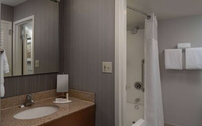 Private guest bathroom with shower and free toiletries at Sonesta Select Chattanooga Hamilton Place.