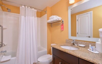 Guest bathroom with shower at Towneplace Suites By Marriott Arundel Mills.