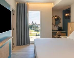 King bed with TV at Terradamari Resort & Spa Marina Di Modica.