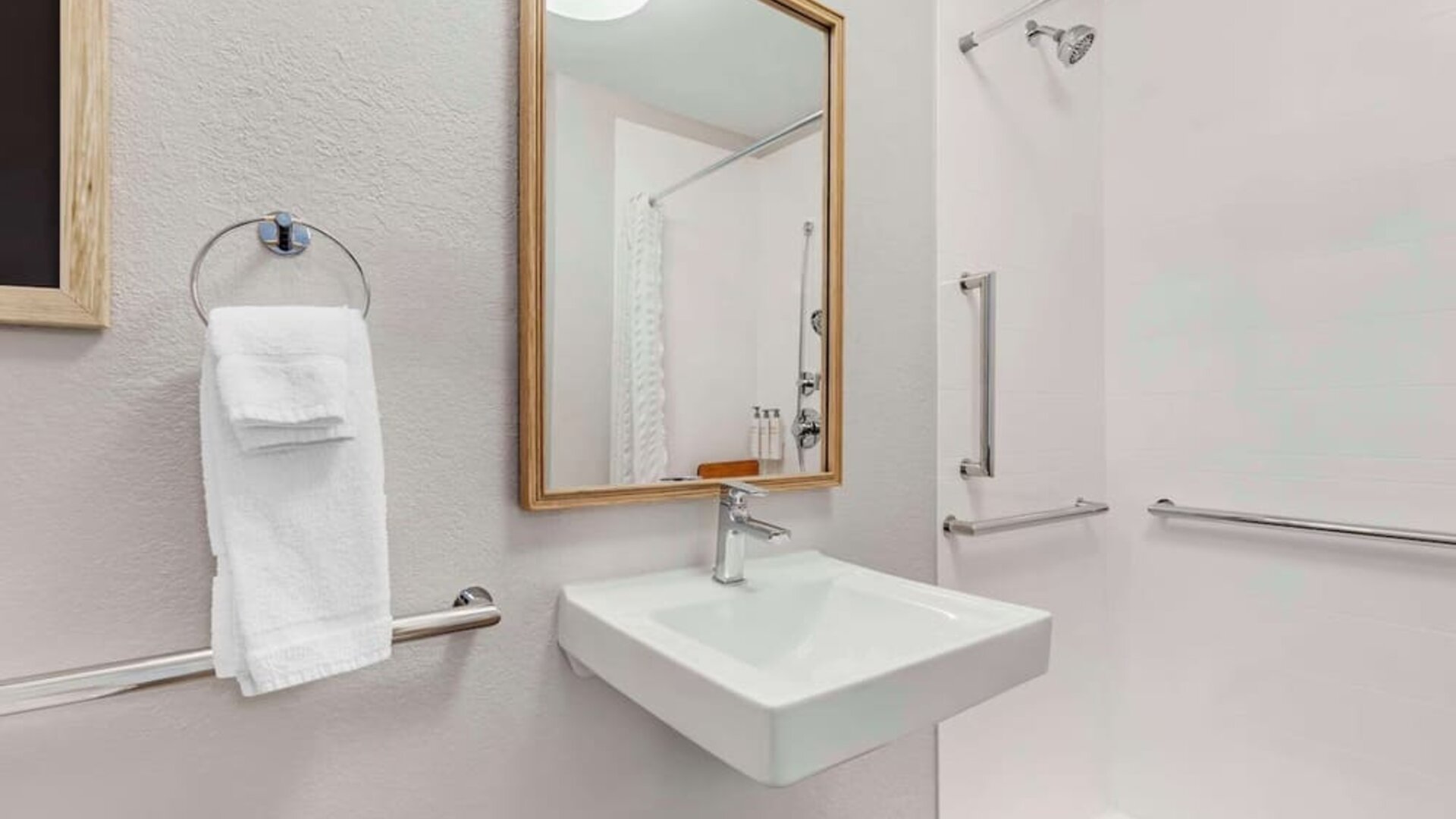 Private guest bathroom with shower and free toiletries at Sonesta Simply Suites Baltimore BWI Airport.