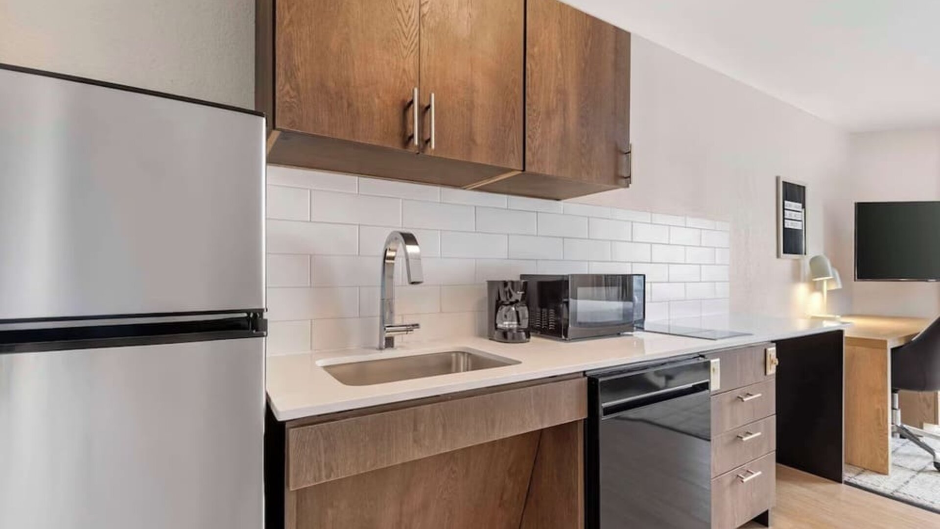 In-room kitchen with fridge, sink and microwave at Sonesta Simply Suites Baltimore BWI Airport. 