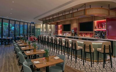 On-site bar with seating and lounge area at Sonesta Miami Airport.