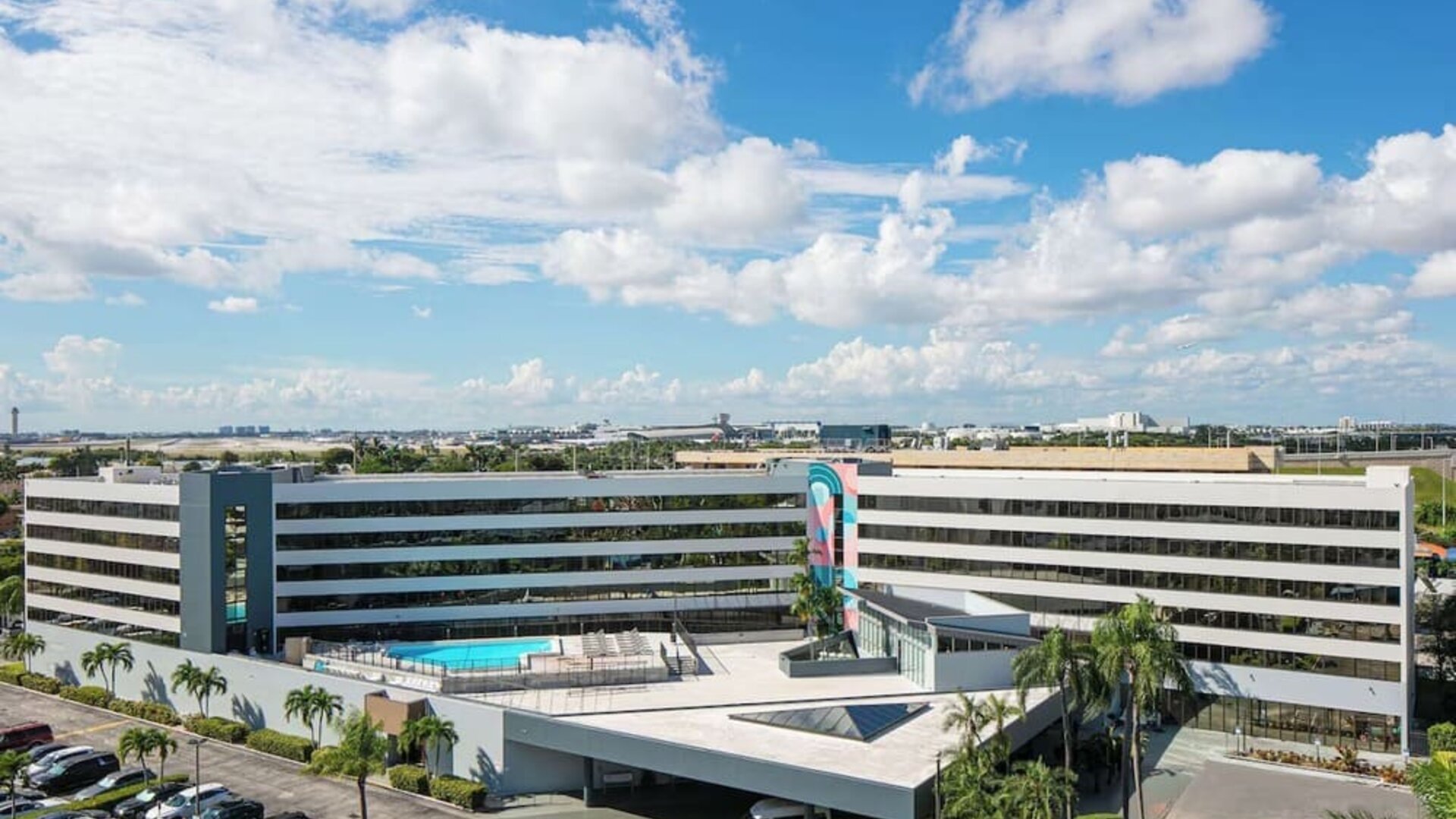 Exterior view of Sonesta Miami Airport and parking area. 
