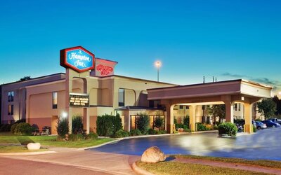 Hotel entrance and parking area at Hampton Inn Columbus-East. 