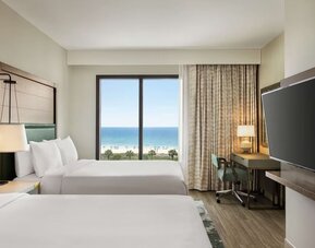 Day use twin room with sea view, work desk and private bathroom at Embassy Suites By Hilton Panama City Beach Resort.