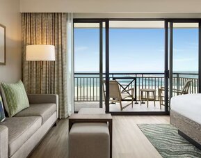 Day use suite with balcony and lounge area at Embassy Suites By Hilton Panama City Beach Resort.