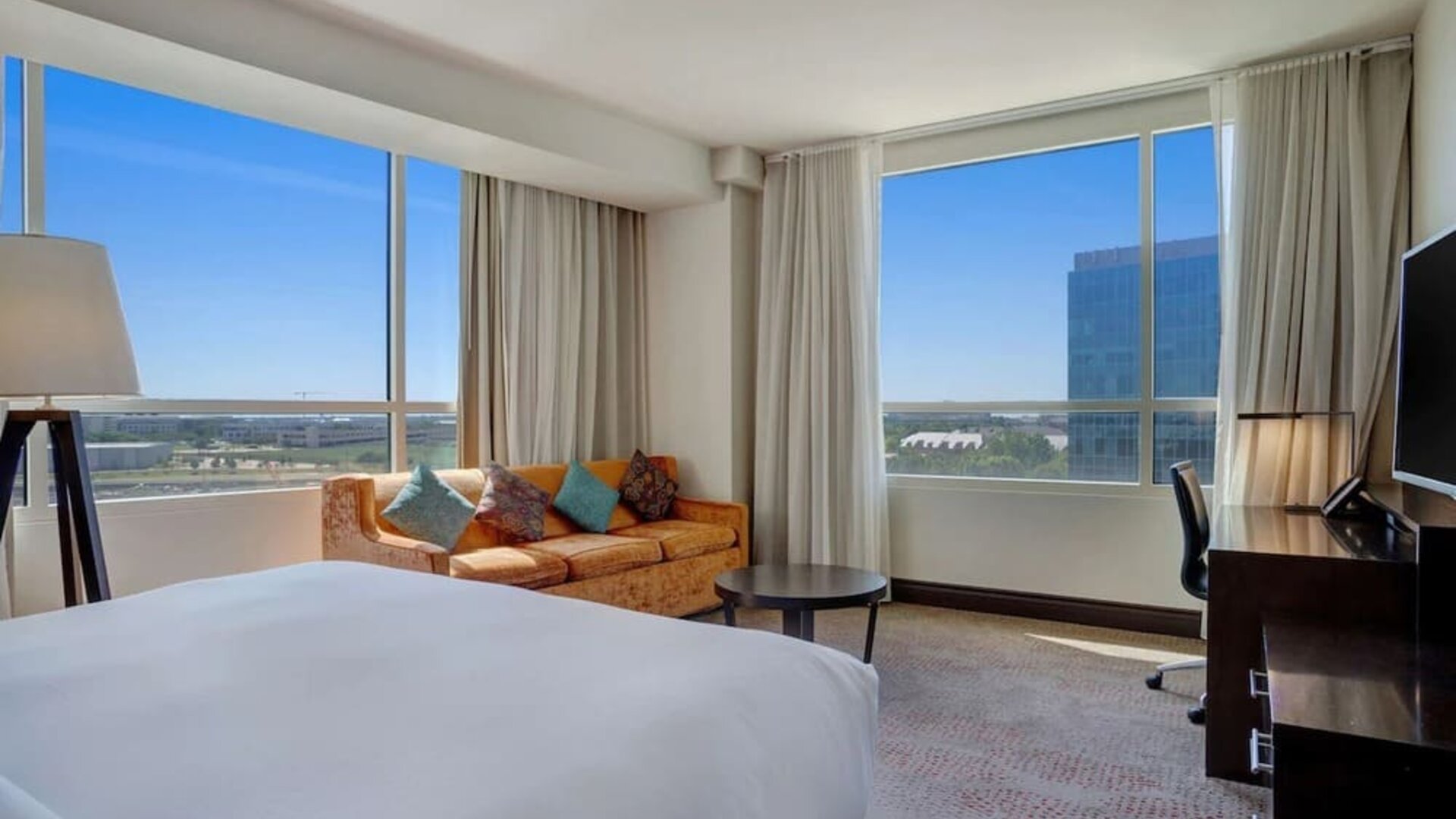 Day use room with work desk and a view of the city at Hilton Dallas/ Plano Granite Park.