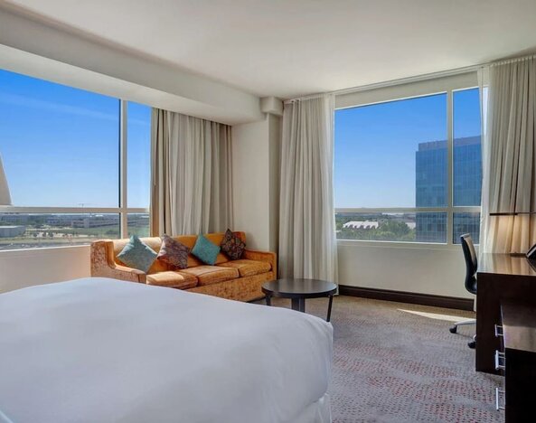 Day use room with work desk and a view of the city at Hilton Dallas/ Plano Granite Park.