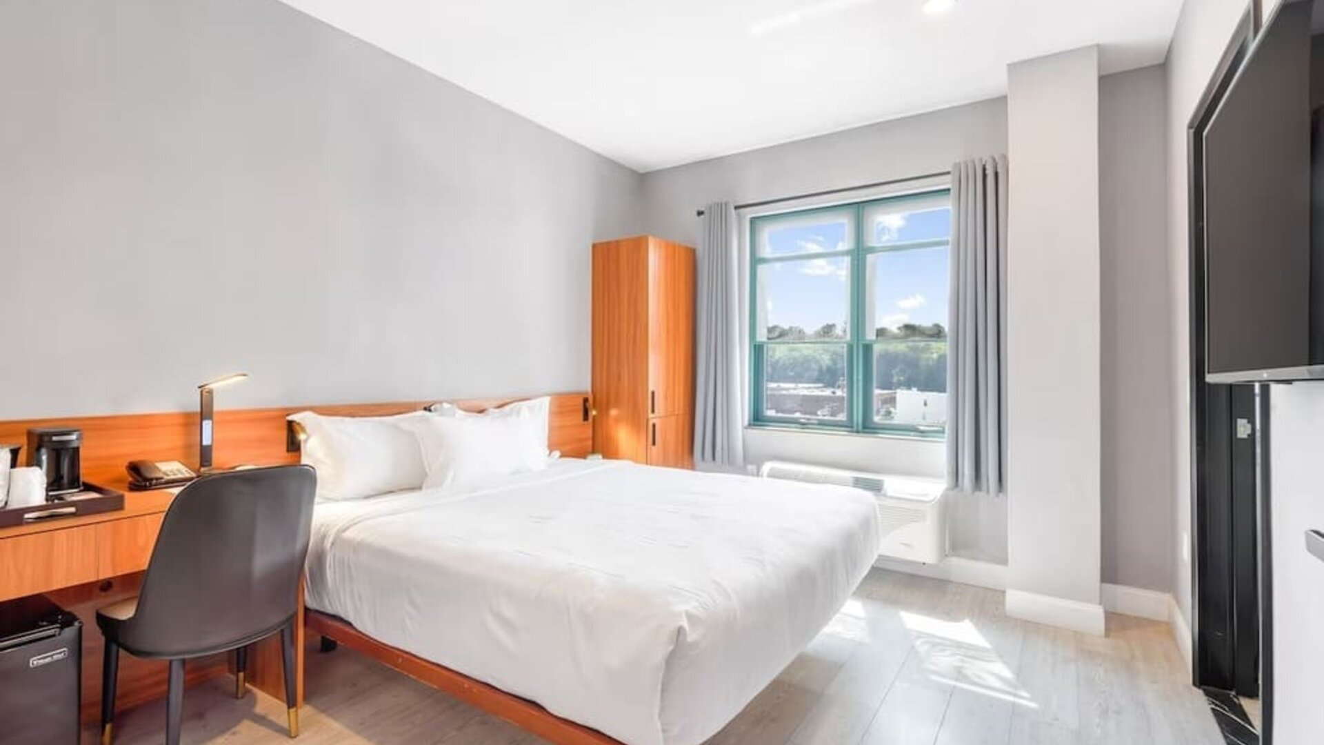 Day use room with work desk and natural light at Liberty View Brooklyn Hotel.
