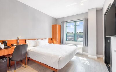 Day use room with work desk and natural light at Liberty View Brooklyn Hotel.
