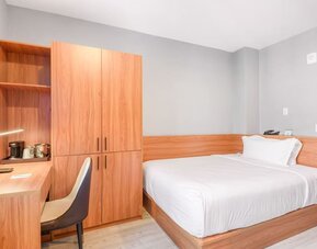 Day use room with work desk and natural light at Liberty View Brooklyn Hotel.