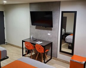 Day use room with TV at Exclusivo Inn & Suites. 