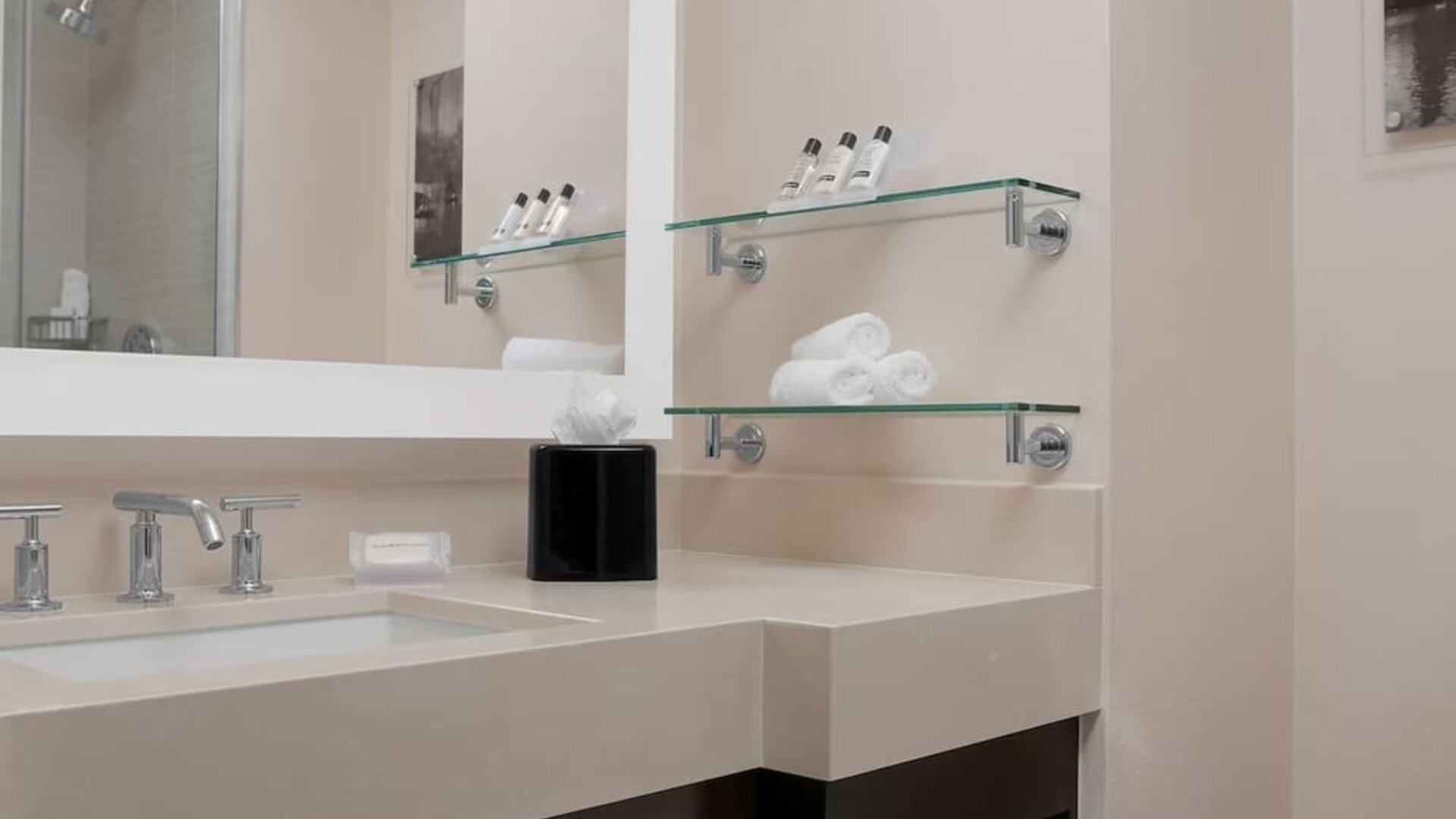 Private guest bathroom with shower and free toiletries at Hilton Garden Inn New York/Times Square Central.