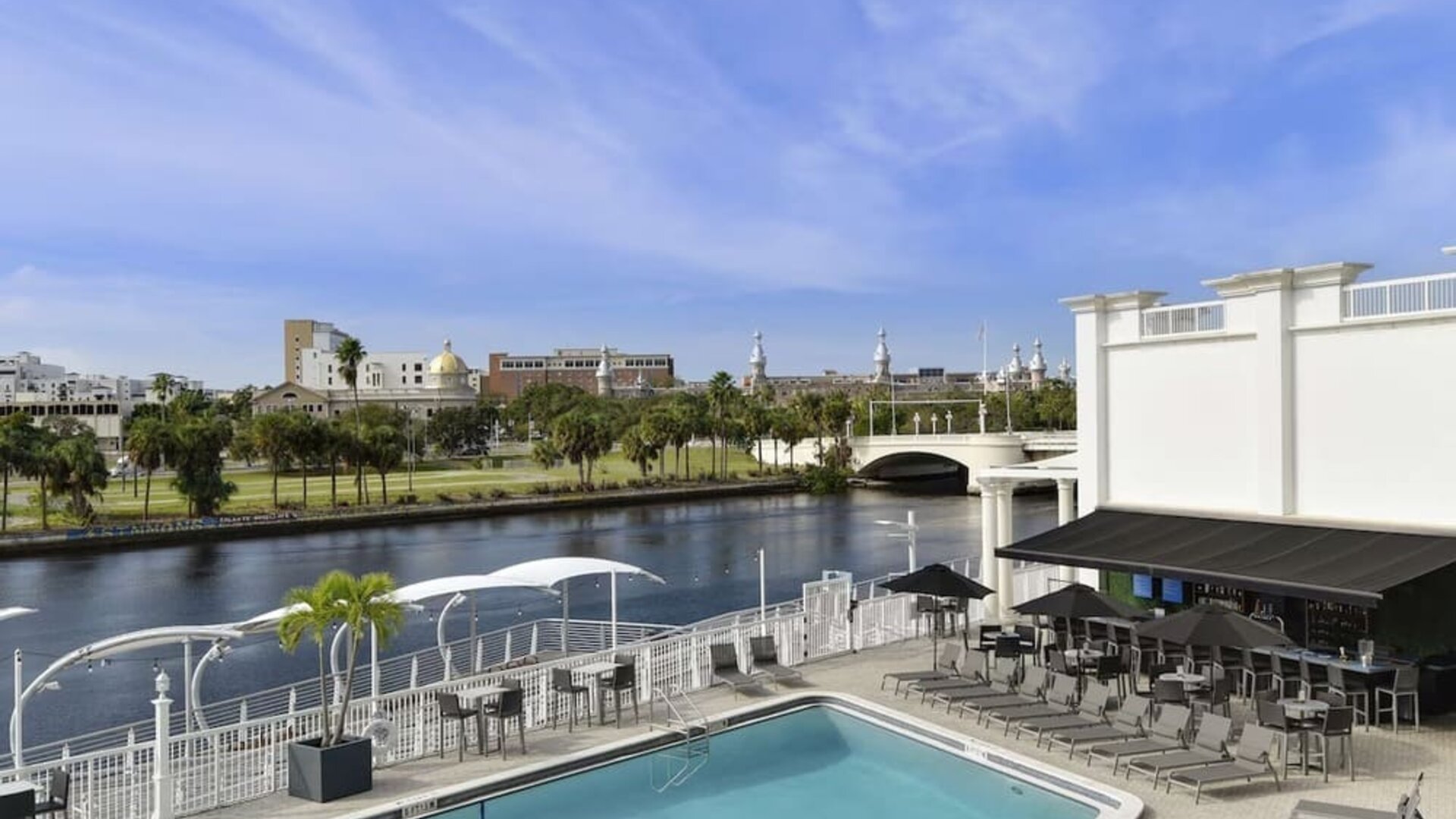 Outdoor pool with lounge area at Hotel Tampa Riverwalk.