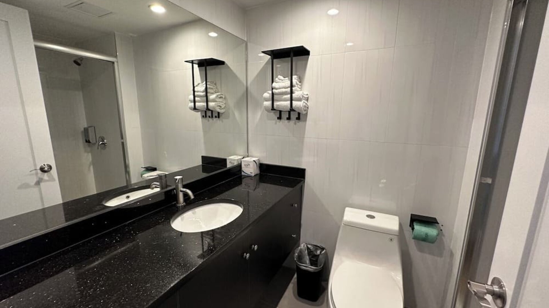 Private guest bathroom with shower and free toiletries at Regal Inn & Suites New York.