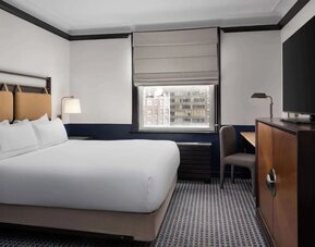 Standard room with work desk and TV screen at Hilton Orrington/Evanston.