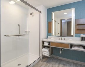 Private guest bathroom with shower and free toiletries at Hilton Garden Inn Cincinnati Midtown.