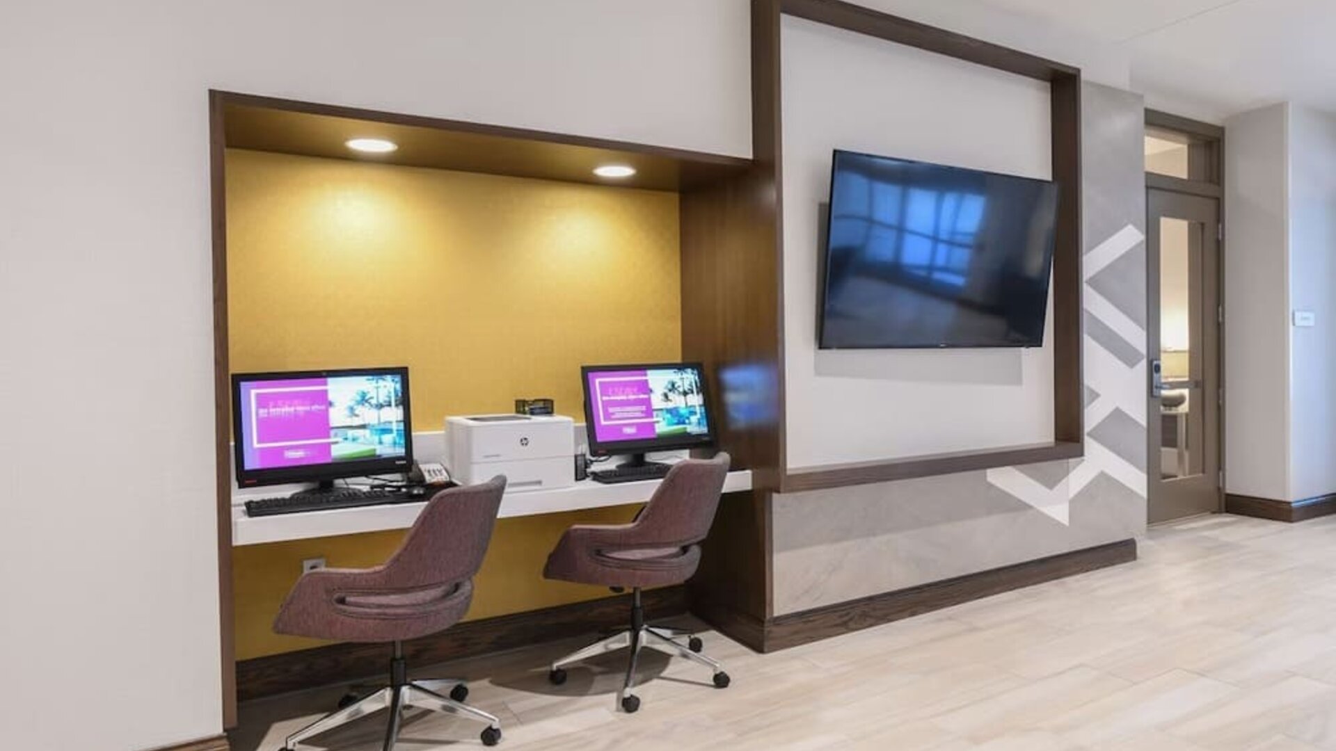 Business center with computers, printer and ergonomic chairs at Hilton Garden Inn Cincinnati Midtown.