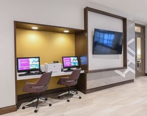 Business center with computers, printer and ergonomic chairs at Hilton Garden Inn Cincinnati Midtown.