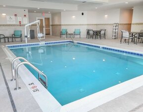 Indoor pool with lounge chairs at Hilton Garden Inn Cincinnati Midtown.