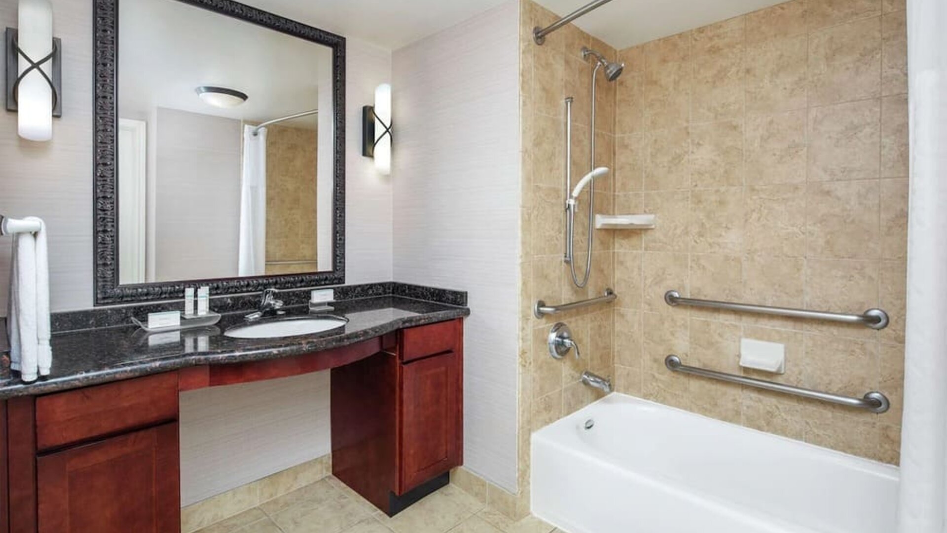 Private guest bathroom with combined shower and tub at Homewood Suites By Hilton Agoura Hills.