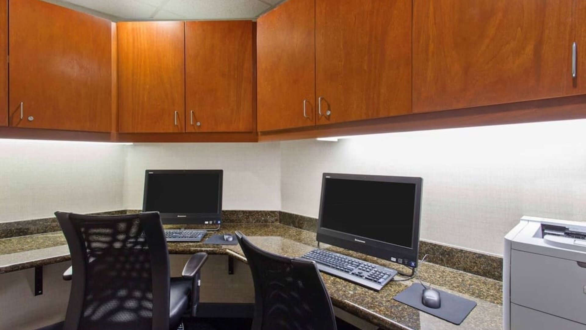 Business center with computers, printer and ergonomic chairs at Hampton Inn & Suites Clovis-Airport North.