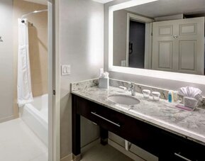 Private guest bathroom with combined tub and shower atHomewood Suites By Hilton San Jose Airport-Silicon Valley.