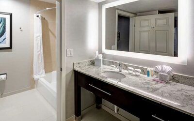 Private guest bathroom with combined tub and shower atHomewood Suites By Hilton San Jose Airport-Silicon Valley.
