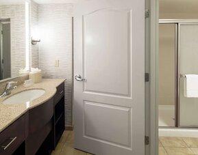 Private guest bathroom with shower and free toiletries at Homewood Suites By Hilton Fresno Airport/Clovis.