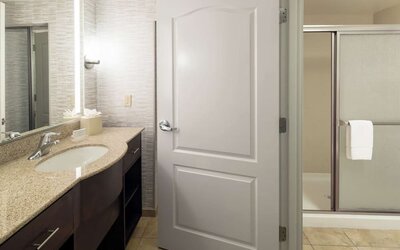 Private guest bathroom with shower and free toiletries at Homewood Suites By Hilton Fresno Airport/Clovis.