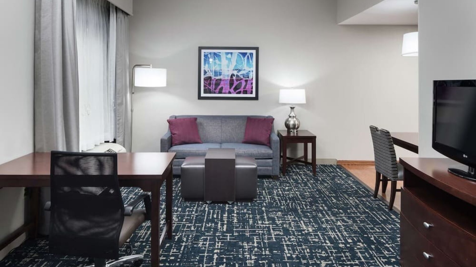 Day use room's workspace and lounge area at Homewood Suites By Hilton Fresno Airport/Clovis.