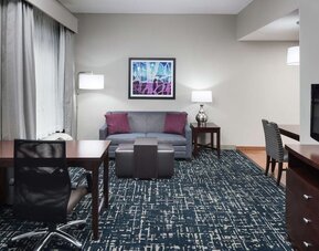 Day use room's workspace and lounge area at Homewood Suites By Hilton Fresno Airport/Clovis.