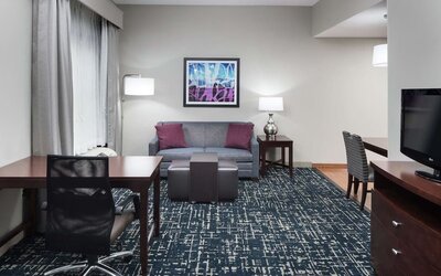 Day use room's workspace and lounge area at Homewood Suites By Hilton Fresno Airport/Clovis.