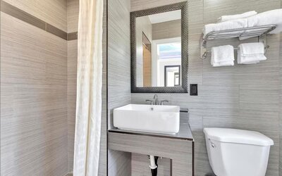 Private bathroom with shower at Mid City Inn - Los Angeles.