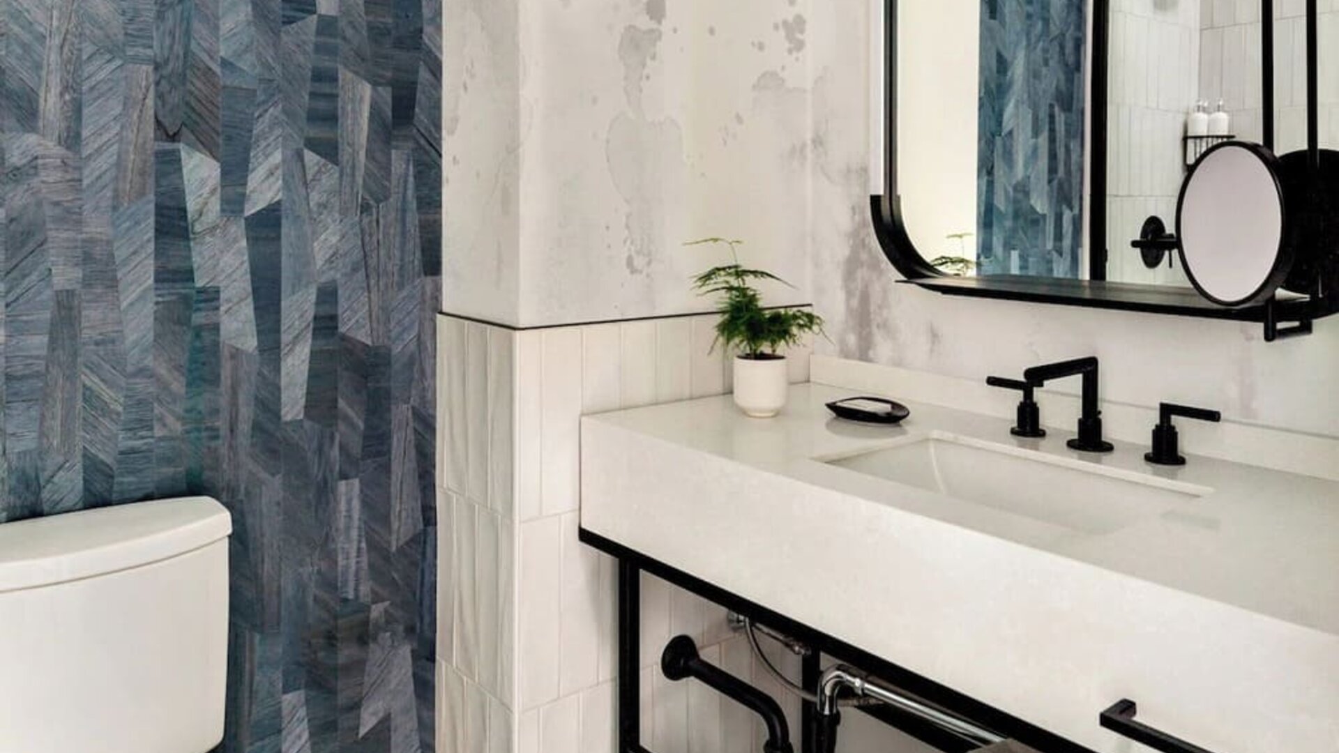 Private guest bathroom with shower and free toiletries at Kimpton Theta New York - Times Square.