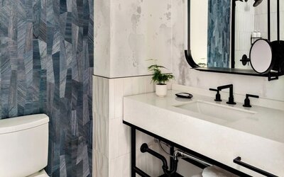 Private guest bathroom with shower and free toiletries at Kimpton Theta New York - Times Square.
