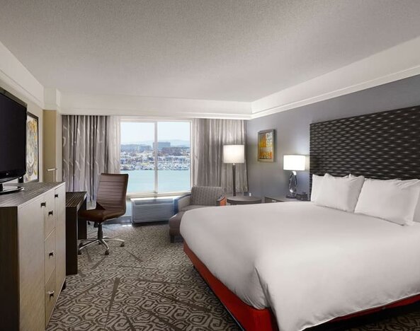 Day use room with king bed, work desk and TV screen at DoubleTree By Hilton San Francisco Airport North Bayfront.