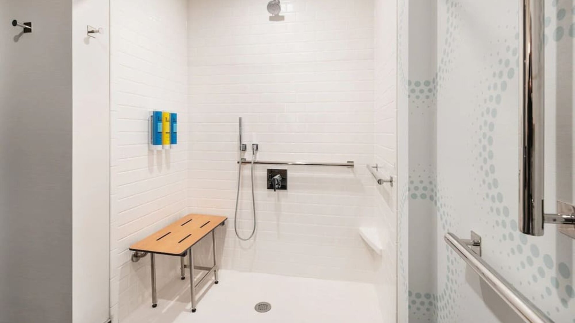 Accessible private guest bathroom with shower and free toiletries at 	Home2 Suites By Hilton Denver Downtown Convention Center.