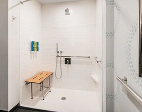 Accessible private guest bathroom with shower and free toiletries at 	Home2 Suites By Hilton Denver Downtown Convention Center.