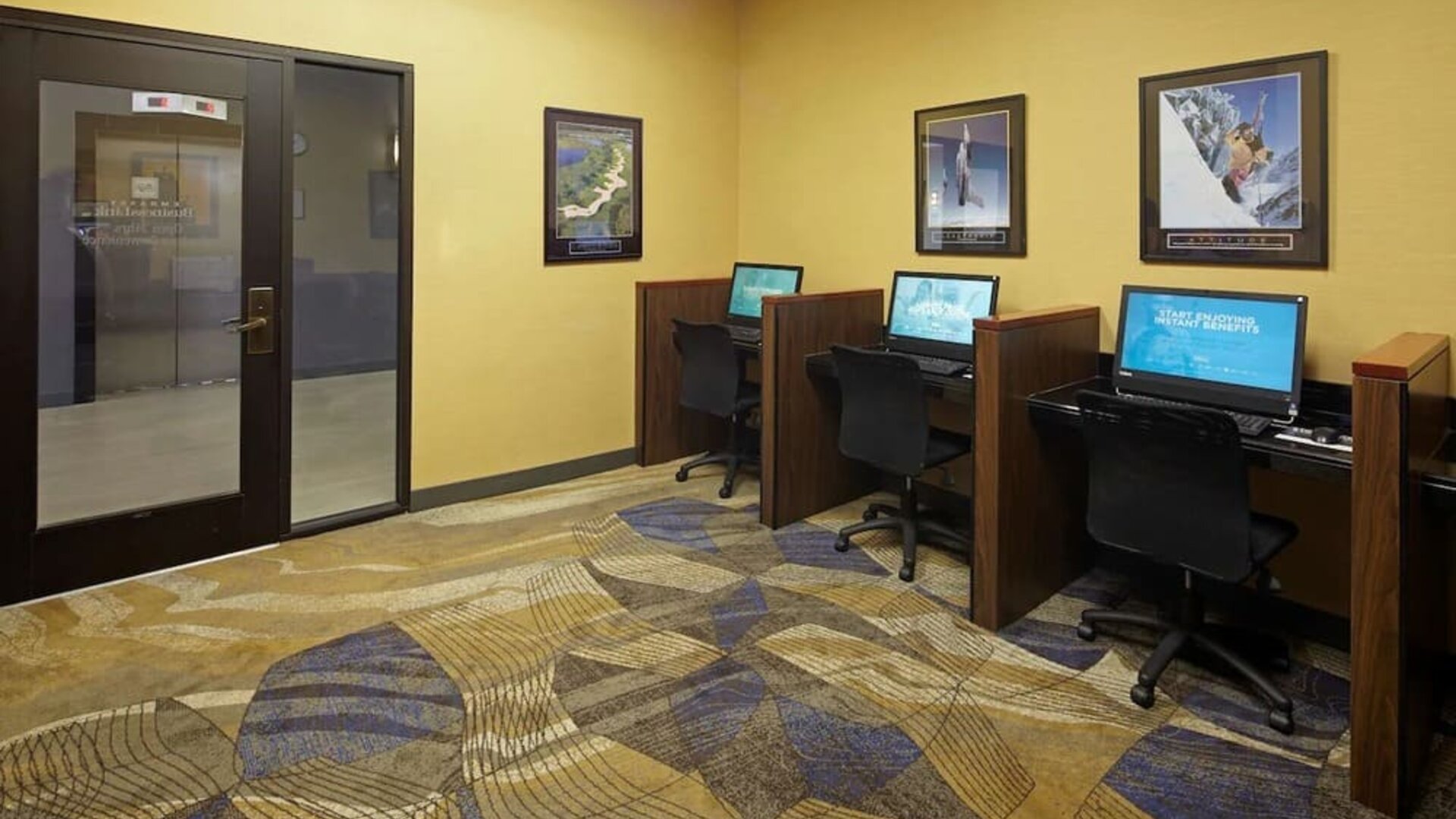 Business center with computers, printer and ergonomic chairs at Embassy Suites By Hilton Los Angeles-Intl Airport North.