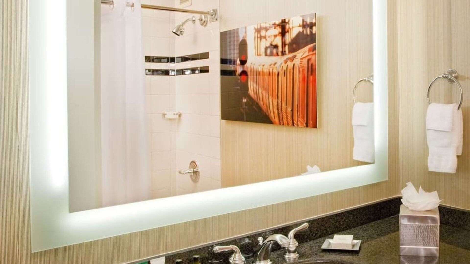 Private guest bathroom with shower and free toiletries at Hilton Newark Airport.