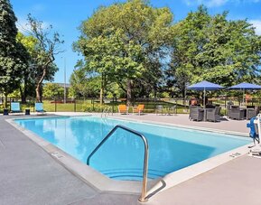 Outdoor pool with lounge chairs at Hampton Inn Chicago/Naperville.