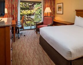 Comfortable king bedroom with balcony at the DoubleTree by Hilton Seattle Airport.