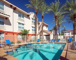 Outdoor pool with lounge chairs at Sonesta Simply Suites Phoenix Scottsdale.