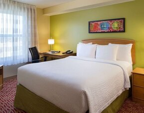 Day use room with king bed and work desk at Sonesta Simply Suites Phoenix Scottsdale.