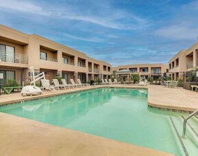 Outdoor pool with lounge chairs at Sonesta Select Scottsdale At Mayo Clinic Campus.
