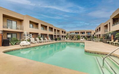 Outdoor pool with lounge chairs at Sonesta Select Scottsdale At Mayo Clinic Campus.